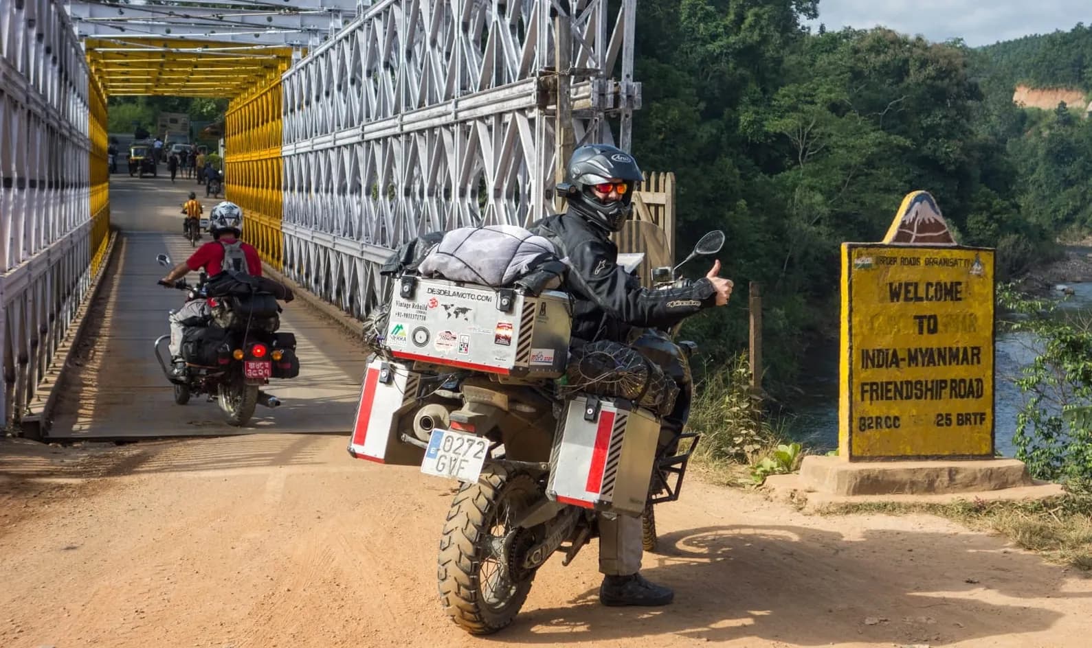 A rider giving a thumbs up beside the loaded BMW GS at the India to Myanmar Friendship Road crossing.